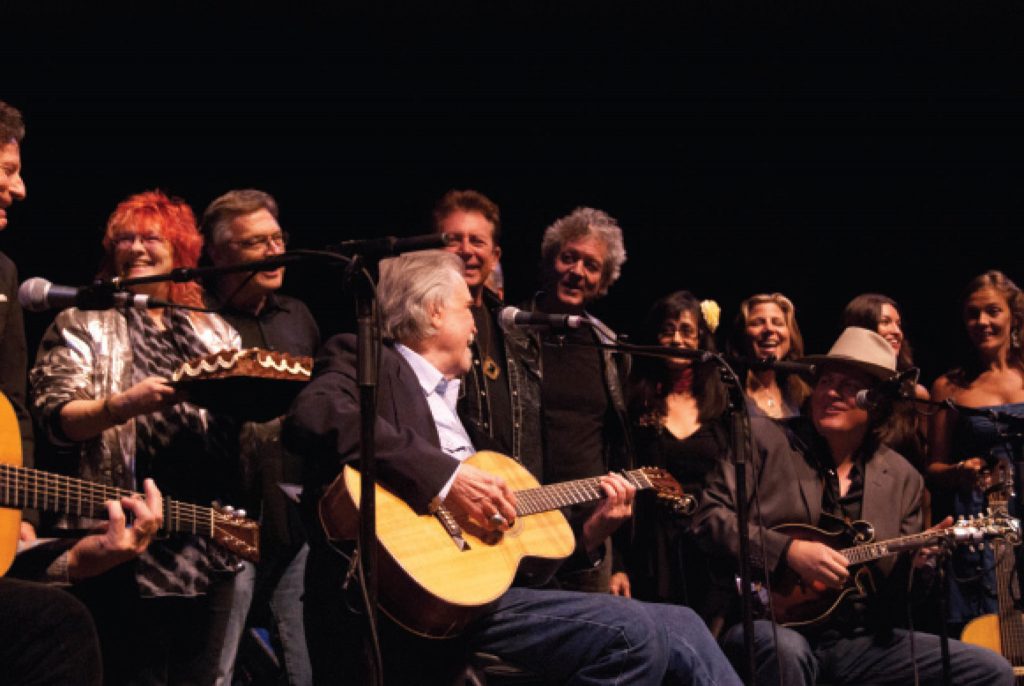 Everybody loves that Guy: (from left) Lyle Lovett, Jessie Scott of MusicFog.com, Terry Allen, Clark, Joe Ely, Rodney Crowell, Rosie Flores, Terri Hendrix, Shawn Camp, and Liz Foster and Kelley Mickwee of the Trishas (Photo by Lynne Margolis)