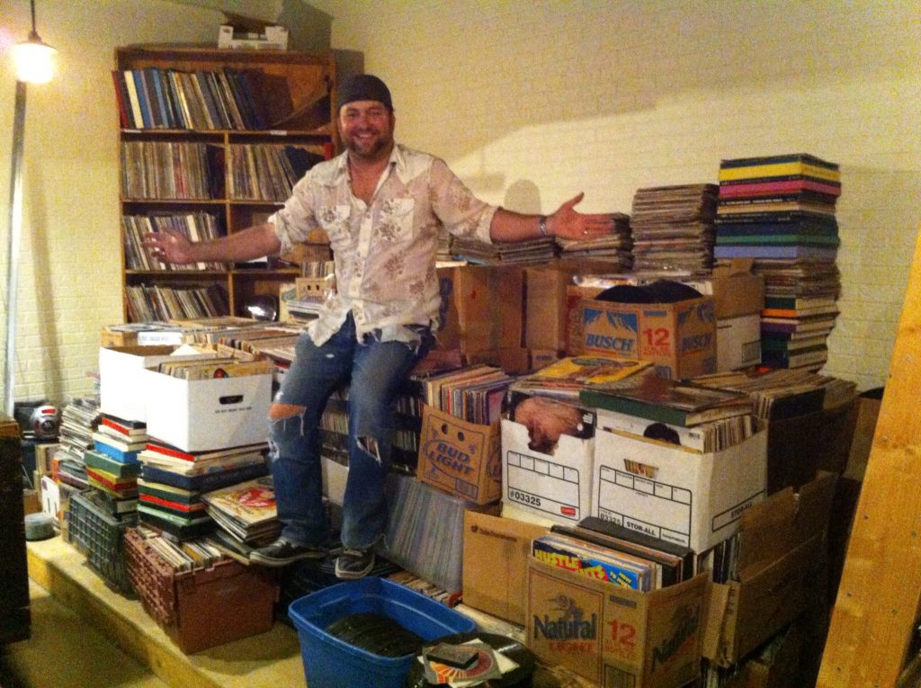 Superfly's Lone Star Music Emporium owner Zach Jennings atop just one of his piles of vinyl.
